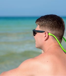 FLOTEZ on sunglasses worn by a guy at the beach