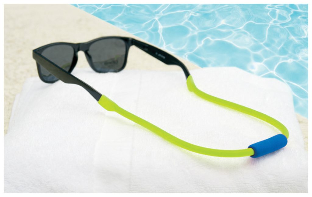 Sunglasses with green flotez on a white towel